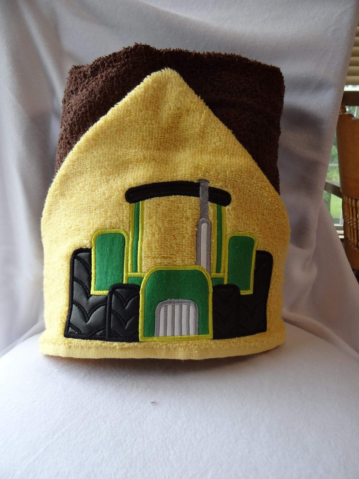 Hooded towel green tractor design appliqué