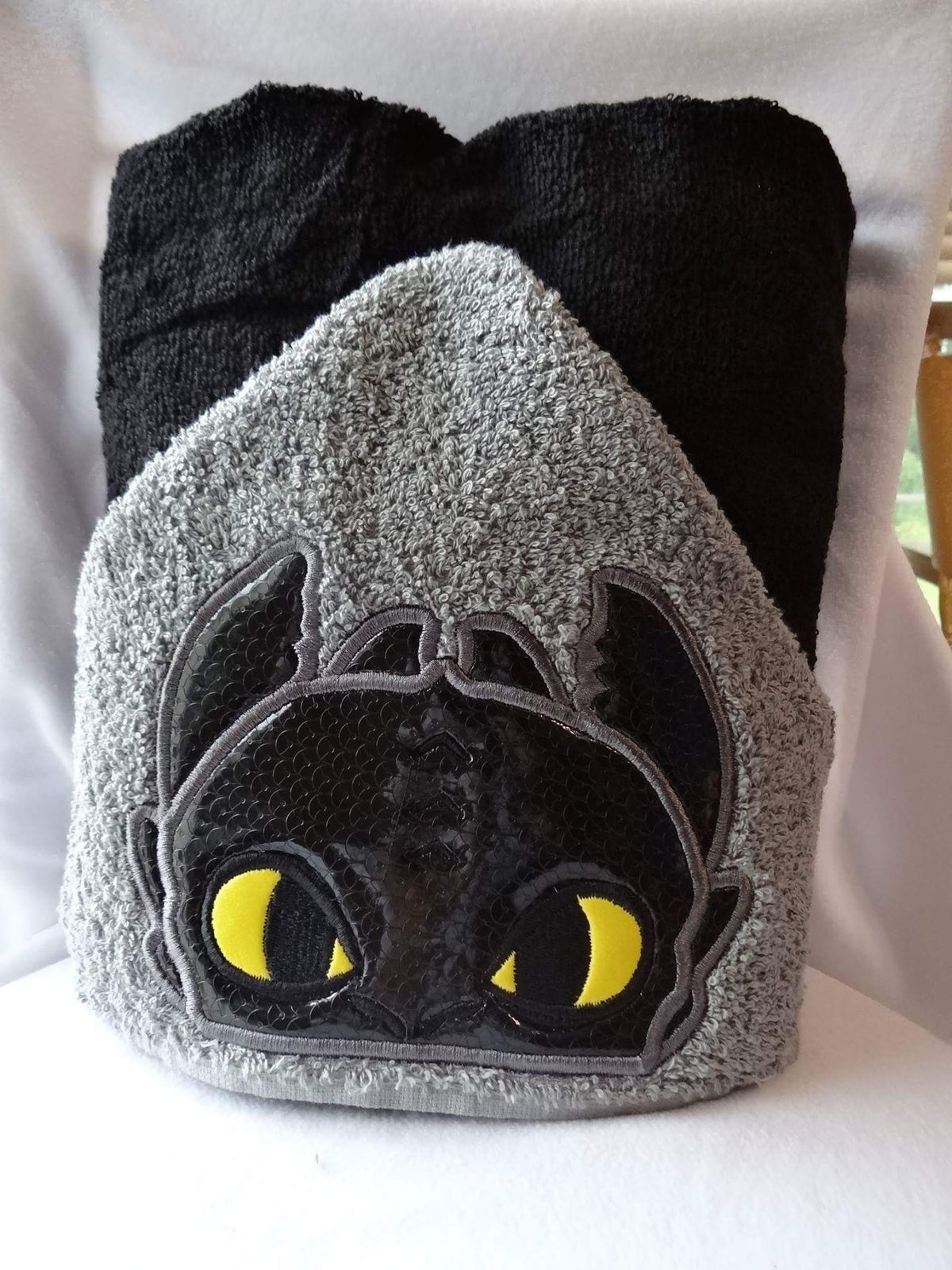Hooded towel black dragon design appliqué
